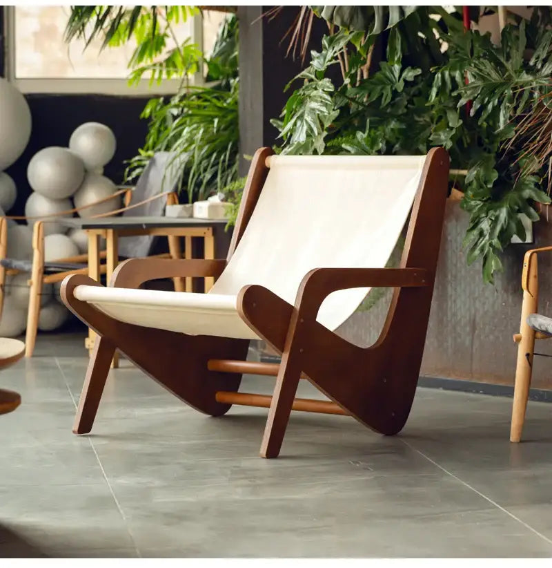 A mid-century brown and cream decorbites canvas recliner with a dark wood frame for stylish living room seating