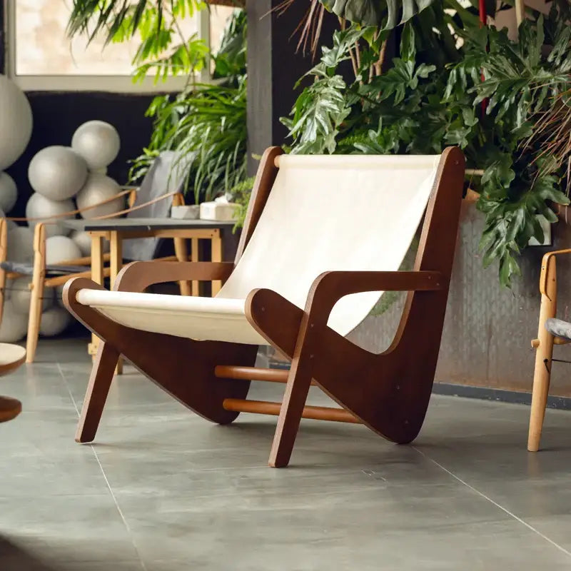 A mid-century brown and cream decorbites canvas recliner with a wooden frame for stylish living room seating