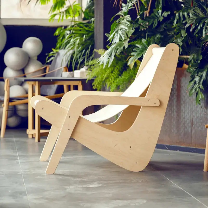 Light-colored wooden mid-century decorbites canvas recliner with curved armrests for living room seating