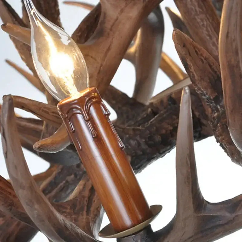 Mid century modern golden antler chandelier with warm-toned candle bulb and polished wooden base by Decorbites antler chandelier