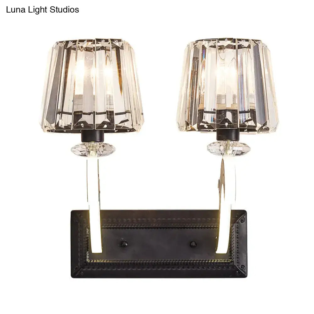 Minimal brass and crystal wall lamp with cone shade featuring crystal faceted dual-light sconce and black metal base