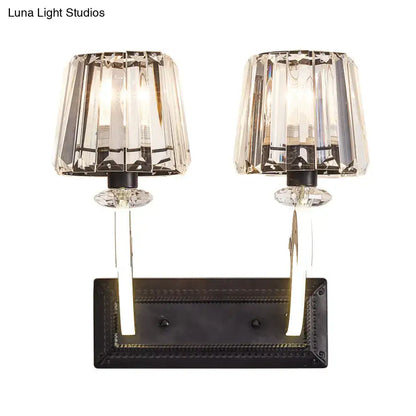 Minimal brass and crystal wall lamp with cone shade featuring crystal faceted dual-light sconce and black metal base