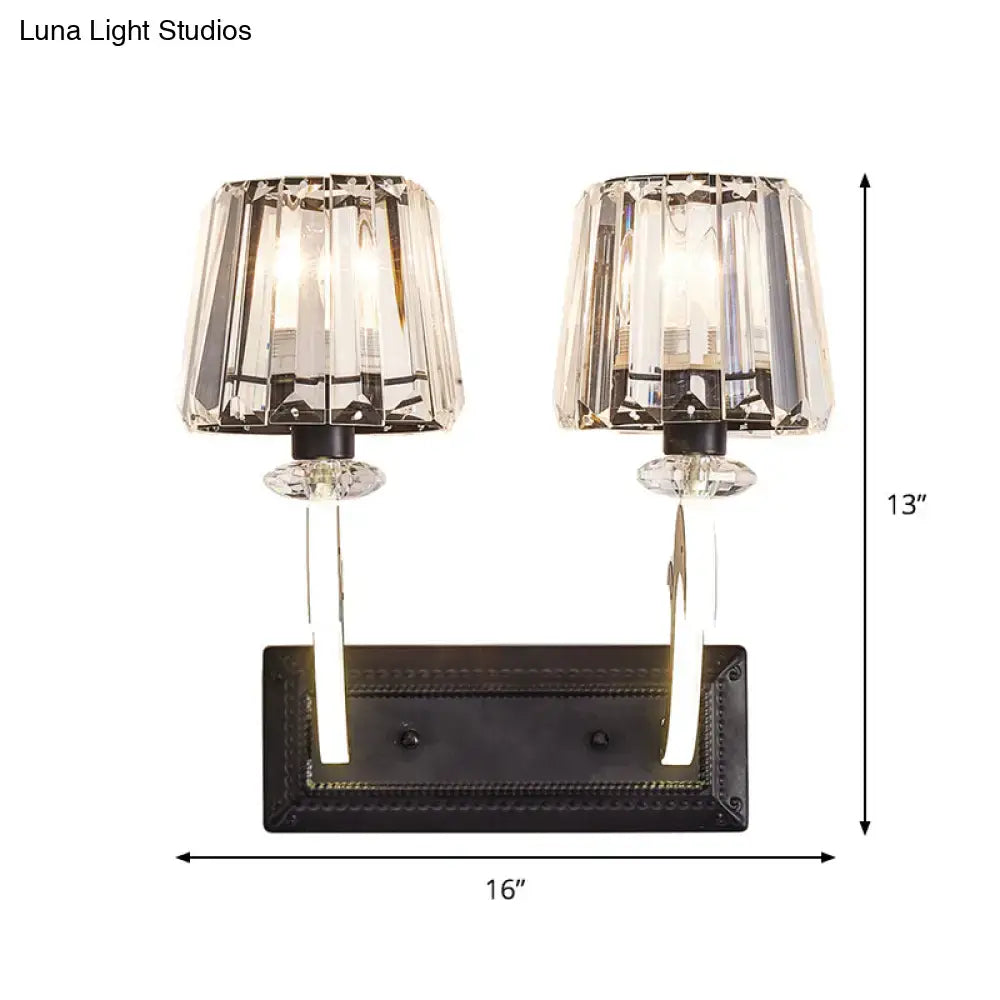 Elegant black metal wall lamp with cone shade, two faceted crystal shades, and clear glass stems for bedroom use