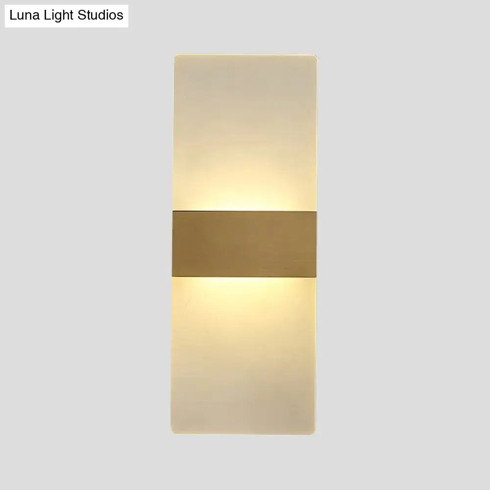 Minimalist acrylic gold wall sconce with a warm diffused glow and central gold-toned metallic accent bar wall lamp
