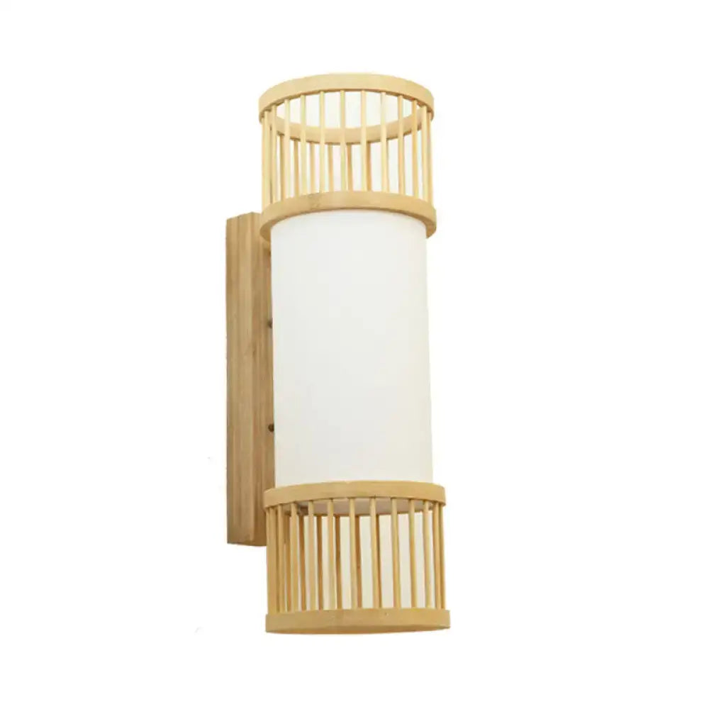 Minimalist bamboo cylinder shade wall sconce with frosted white glass for use as a stairway wall lamp