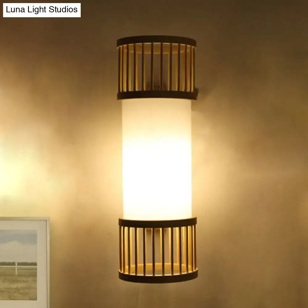 Minimalist warm-toned wall lamp with frosted bamboo cylinder shade and dark metal bands for stairway lighting