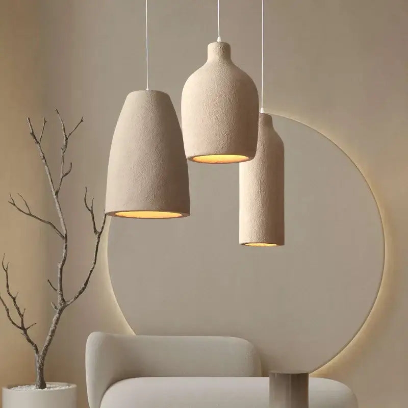 Three beige textured cement chandelier light pendant lights with warm glow for modern minimalist living room decorbites chandelier light