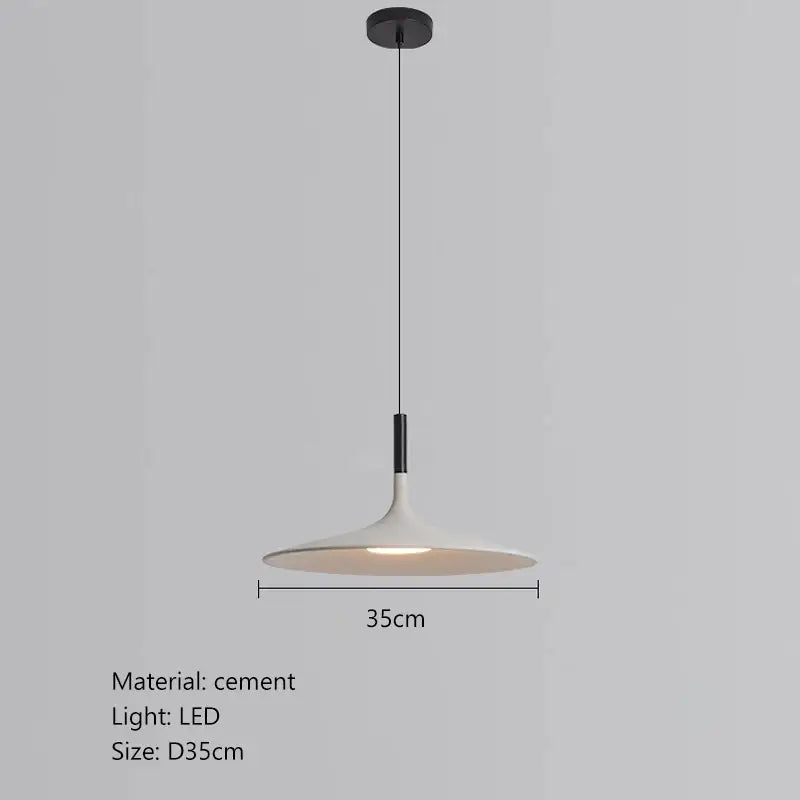 A sleek minimalist beige cement ufo led pendant light with matte white cement shade and black hardware for dining room