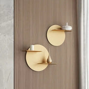 Minimalist beige round metal wall storage shelf with circular design and slender horizontal ledge for living room wall storage