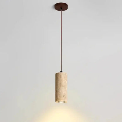 Minimalist beige travertine cylindrical pendant light with textured stone body and dark metal hardware for dining table