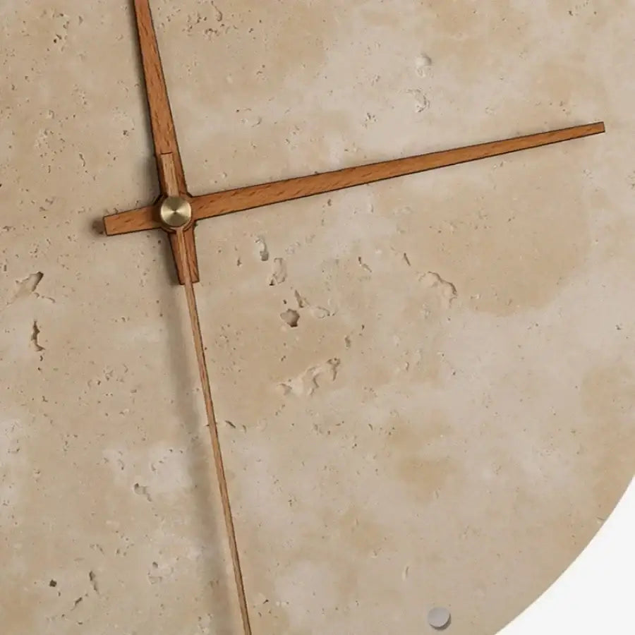 Minimalist beige travertine wall clock with slender wooden hands and brass accent complements led wall lights