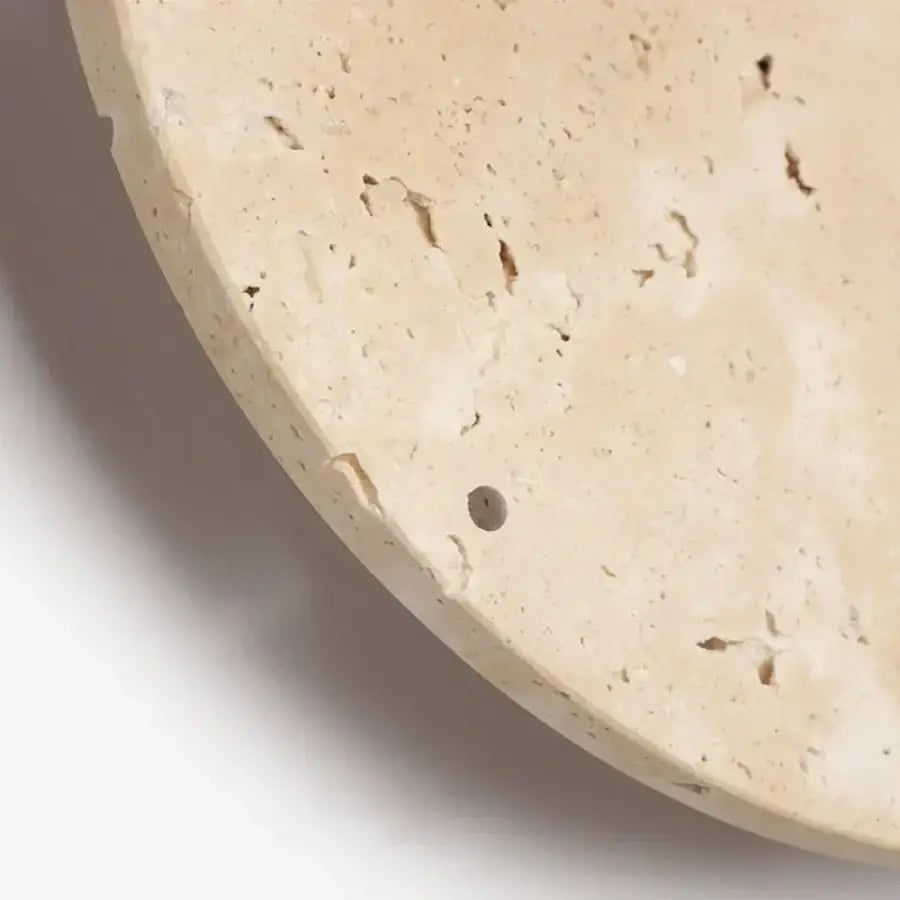 Beige travertine stone clock tray with speckled texture and hole for minimalist led wall lights in bedroom use