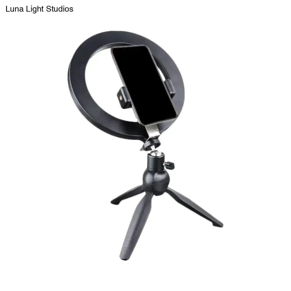 Minimalist black 14 inches fixture ring light with flash lighting mounted on tripod with phone holder for bedroom use