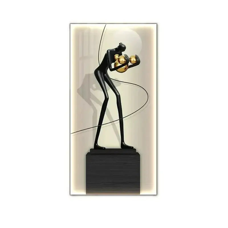 Minimalist black abstract figure luminous canvas wall lamp featuring a sculpture holding golden spheres on dark base