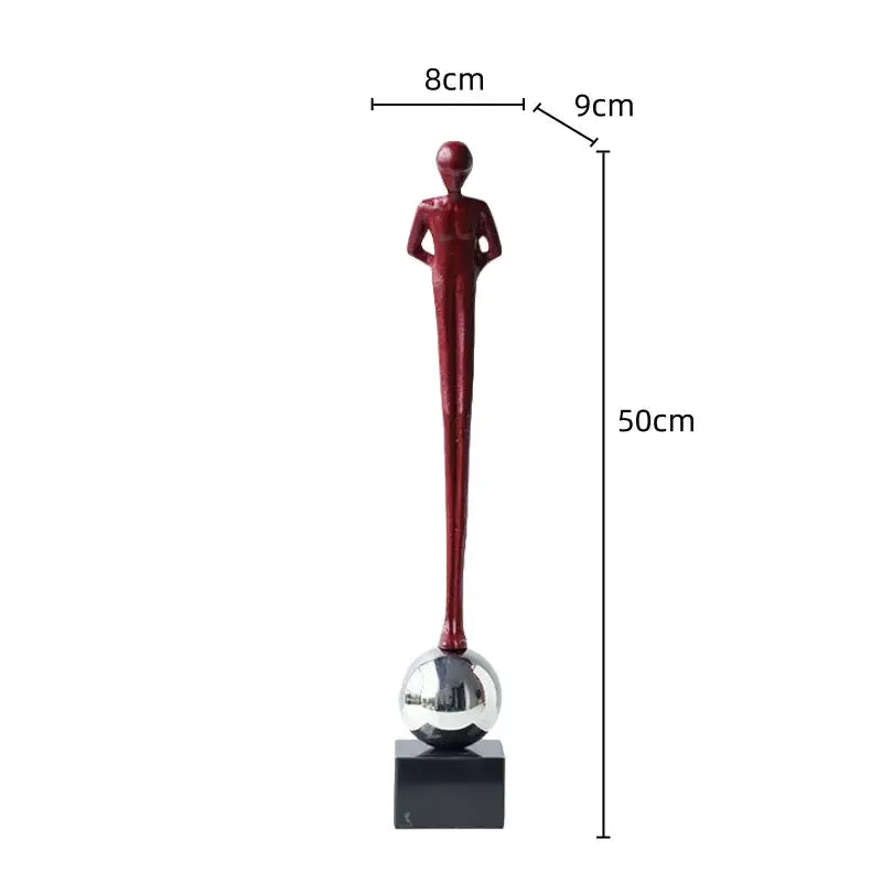 A sleek red metal figurine abstract thinker standing 50cm tall on a silver sphere with a black base for living room decorbites