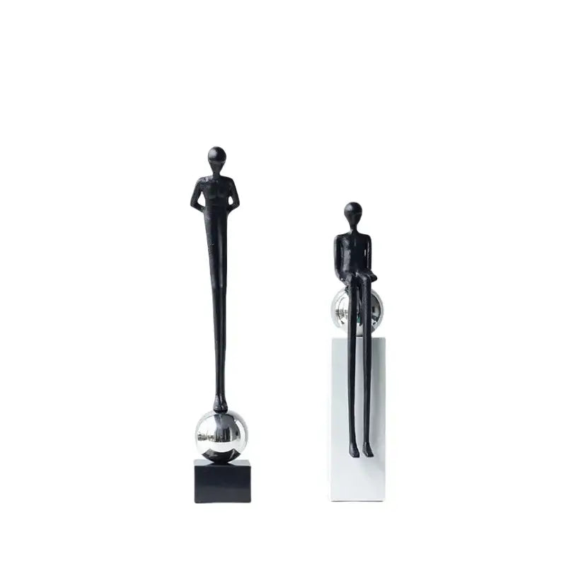 Two minimalist black metal figurines featuring abstract thinker poses on reflective spheres for living room decorbites decor
