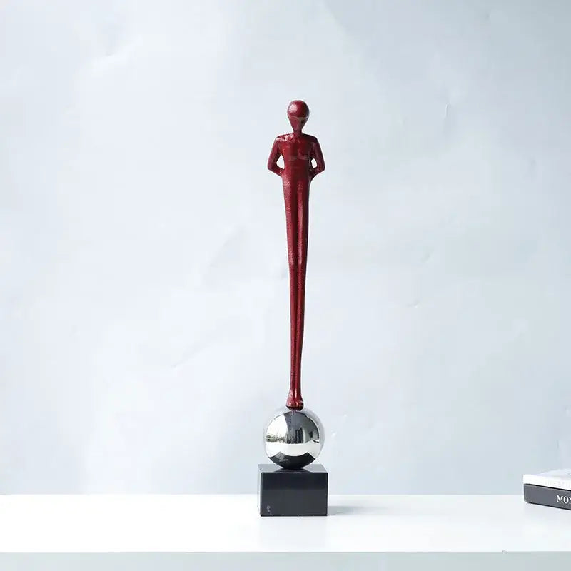 A sleek glossy red metal figurine abstract thinker with hands on hips atop silver sphere for living room decorbites decor