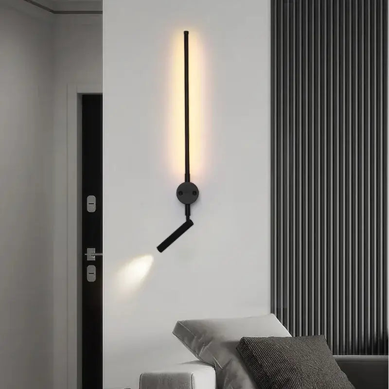 Minimalist black wall lamp with adjustable angle arm and sleek vertical bar emitting warm light by decorbites adjustable angle