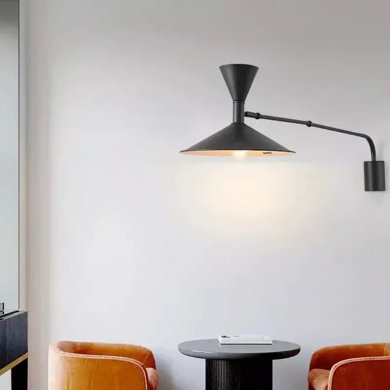 Minimalist black wall lamp with adjustable long arm and warm interior lighting for bedroom use