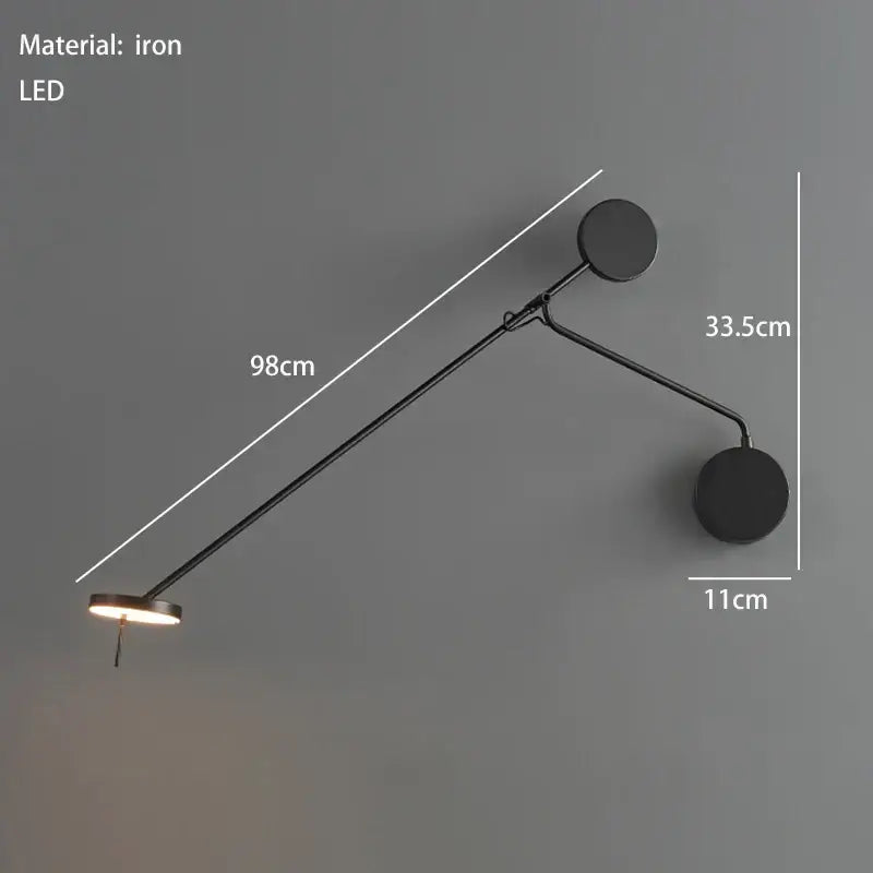 Black iron wall lamp with two circular ends and an adjustable swing arm for minimalist bedroom lighting