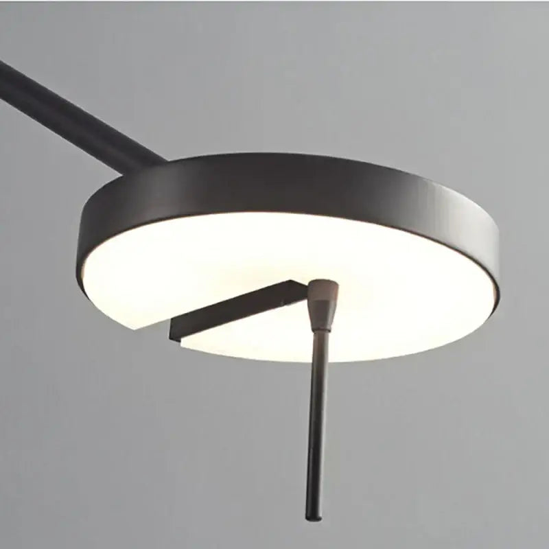 Minimalist black wall lamp with adjustable swing arm and sleek matte finish designed for modern bedroom lighting