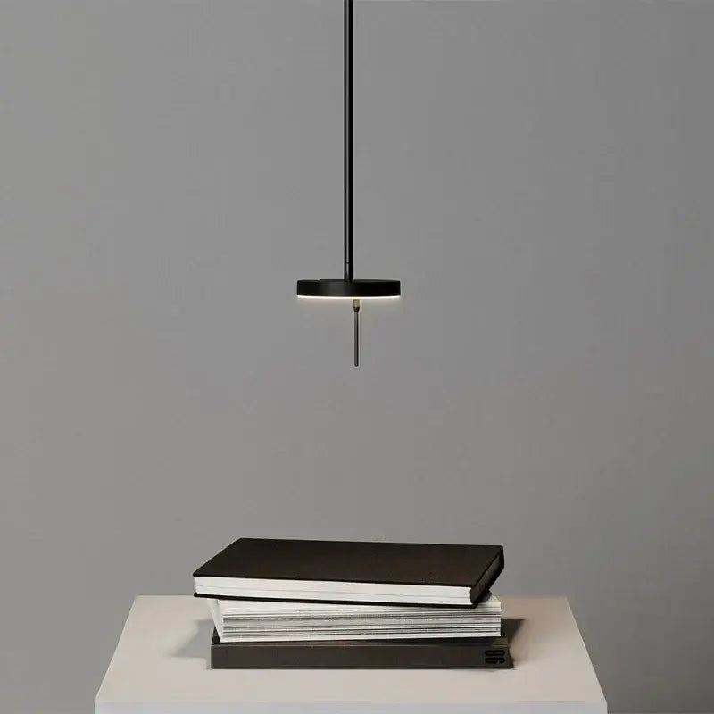 Minimalist black wall lamp with adjustable swing arm and sleek circular shade ideal for bedroom lighting
