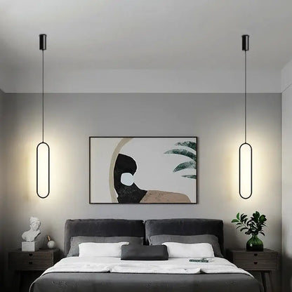 Modern black aluminium led chandelier with sleek elongated oval pendant lights hanging symmetrically above the bed