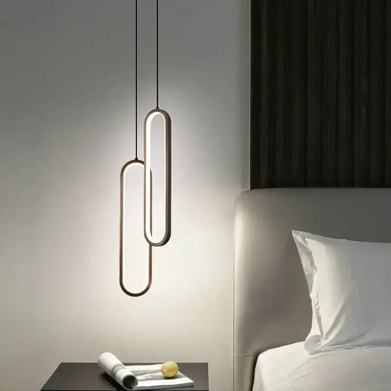Minimalist black aluminium led chandelier features two overlapping oval luminous elements suspended by thin cords for dining room