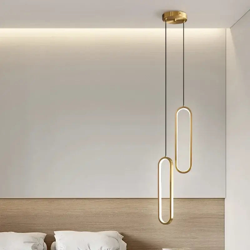 Modern gold-toned oval pendant lights with sleek minimalist design in black aluminium led chandelier for dining room