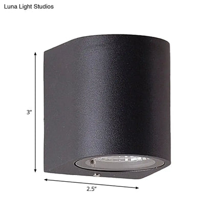 Minimalist black aluminum outdoor cylinder wall light with integrated led direct wired electric for outdoor space