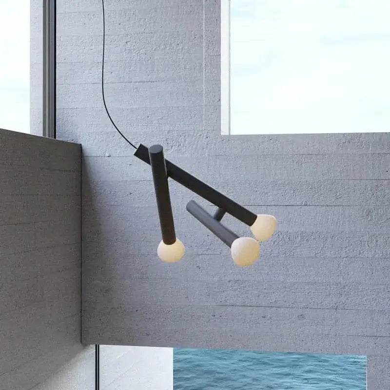 Minimalist black metal pendant light with three frosted glass bulbs ideal for dining room glass pendant lights