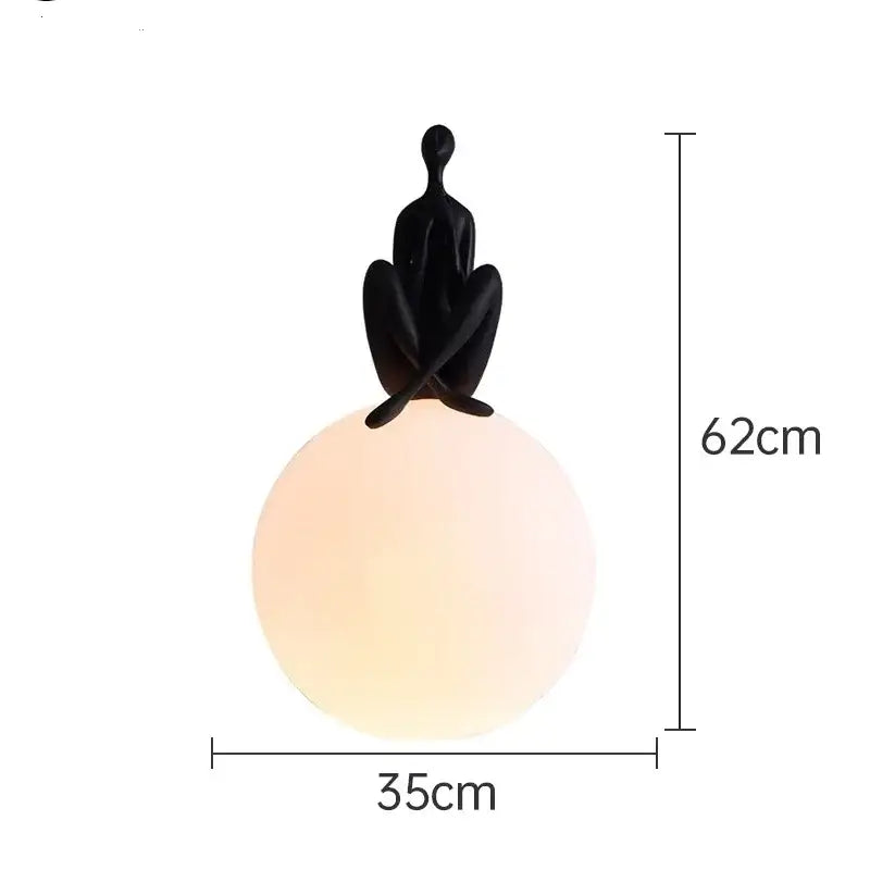 Minimalist black and white humanoid sculpture led table lamp with a glowing spherical lamp for bedroom decorbites table lamp