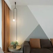 Minimalist black bronze glass ball pendant light with sleek curved cord featuring a glass ball for living room decorbites bronze glass
