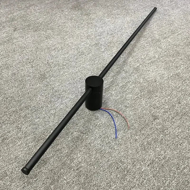 Minimalist black and brushed brass led wall lamp with visible exposed wires and black cylindrical antenna for living room use