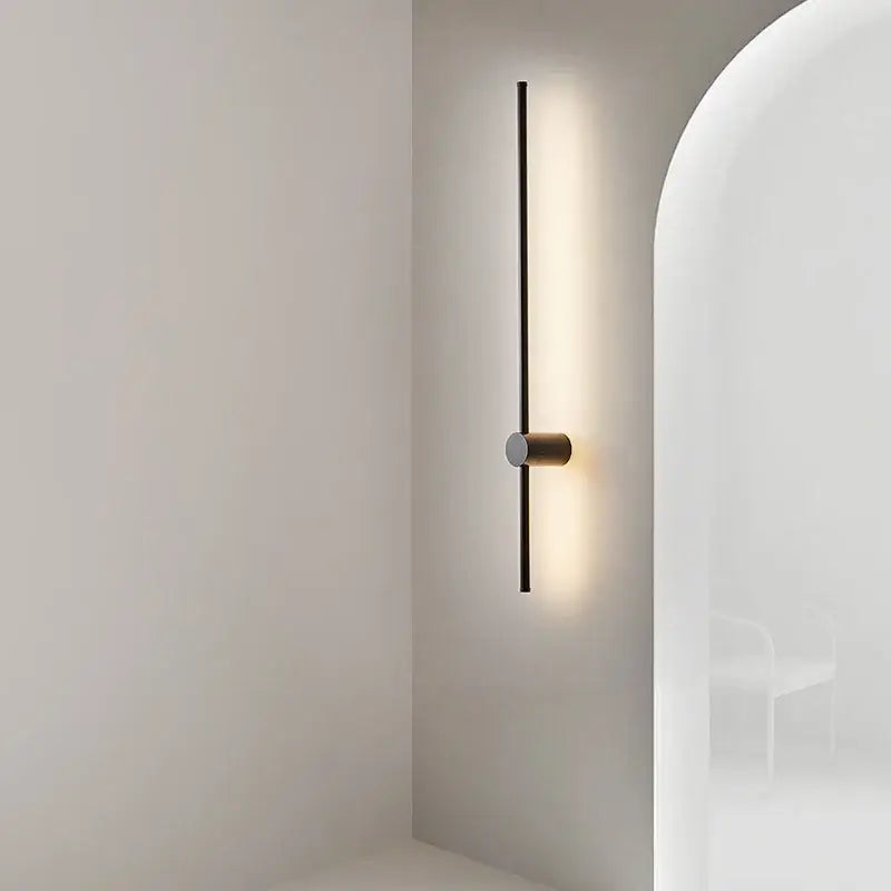 Minimalist black and brushed brass led wall lamp with sleek vertical bar design for living room lighting