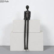 Minimalist black character metal statue with elongated limbs and smooth head as a metal statue desk ornament