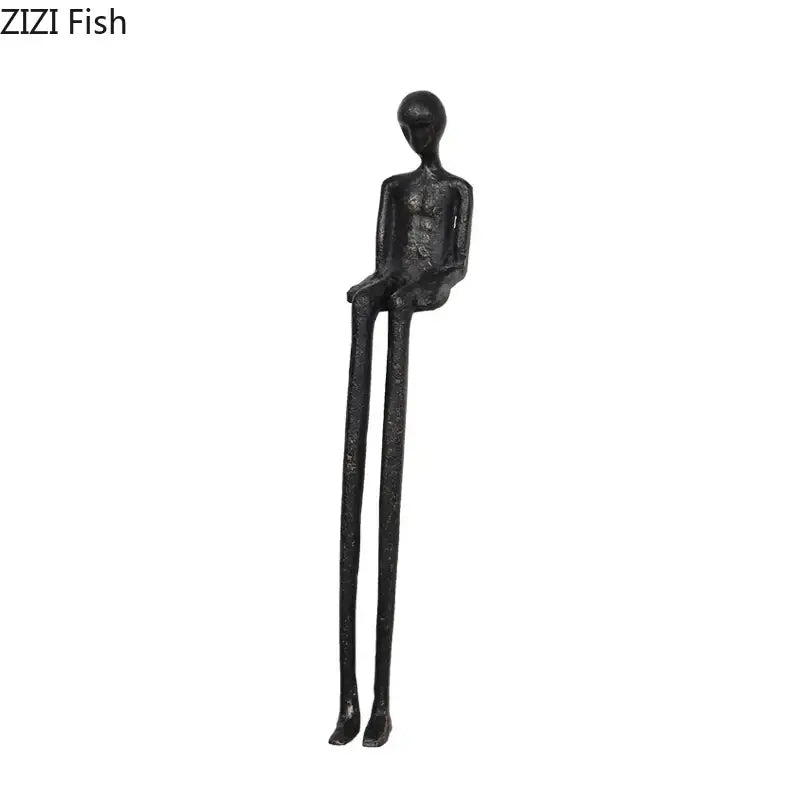 Minimalist black character metal statue of a slender seated humanoid as a metal statue desk ornament for living room