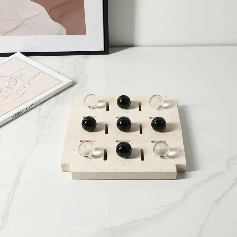 Beige marble tic tac toe board with alternating black and clear geometric glass bead marbles from decorbites chess set