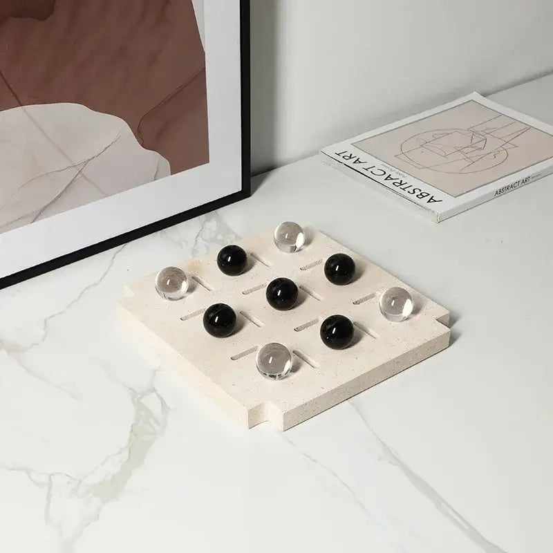 Minimalist black and clear geometric glass bead chess set with a stone tic tac toe board for stylish living room decorbites