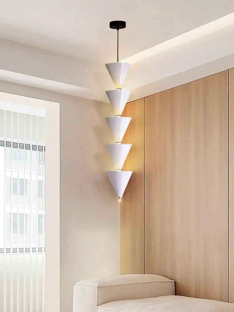 Minimalist cream bedroom chandelier with white conical pendant light, stacked geometric design, and warm led decorbites cream lighting