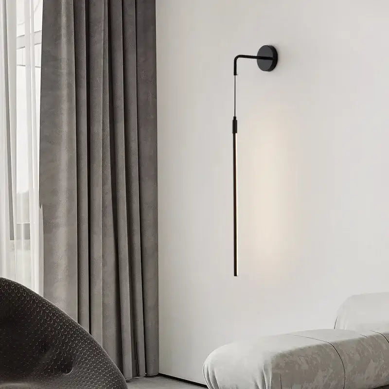 Minimalist black copper wall lamp with sleek slender arm and circular base for modern bedroom decorbites copper wall lamp