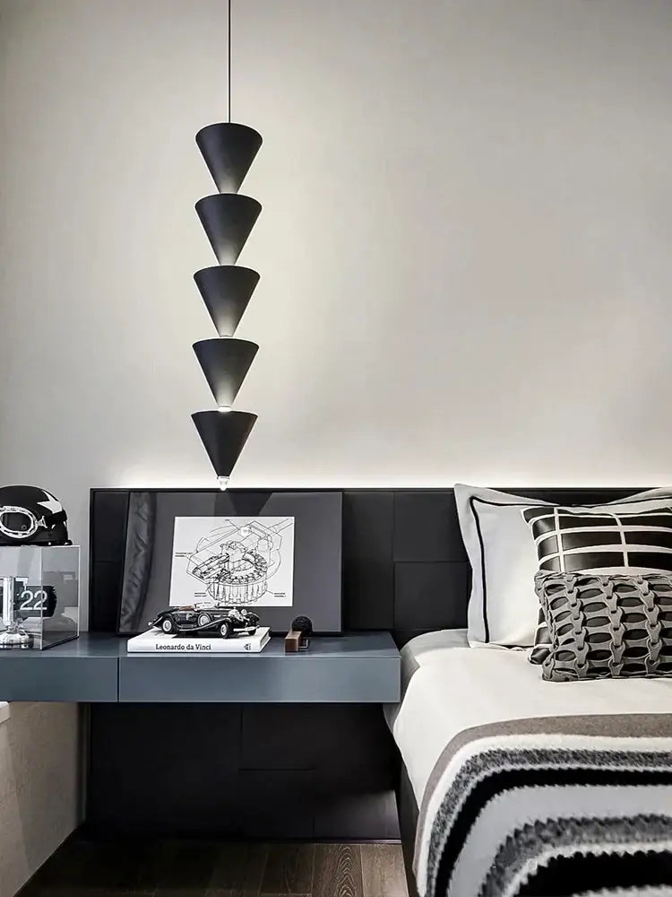 Minimalist black and cream bedroom chandelier with stacked conical pendant light above modern decorbites cream bedroom table