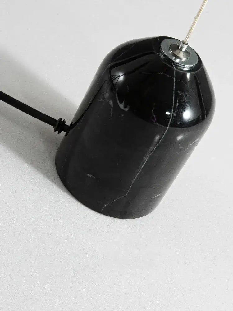 Black marble floor lamp with sleek glossy finish and subtle white veining in minimalist decorbites cone design art style