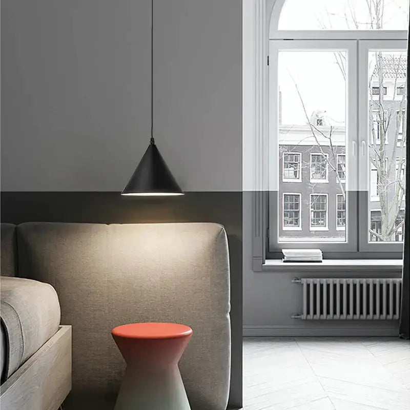 Minimalist black geometric led pendant light with sleek conical design hanging above bed for modern decorbites pendant light decor