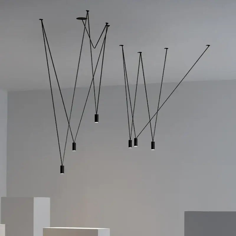Minimalist black geometric pendant lamp with slender cords and cylindrical fixtures for living room decorbites black geometric