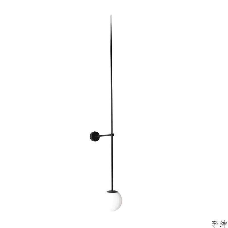 Minimalist black wall light with a sleek metal rod and frosted glass ball led shade by decorbites for bedroom decor