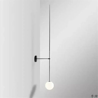 Minimalist black wall light with slender rod and frosted glass ball led designed for bedroom decorbites glass ball sconce