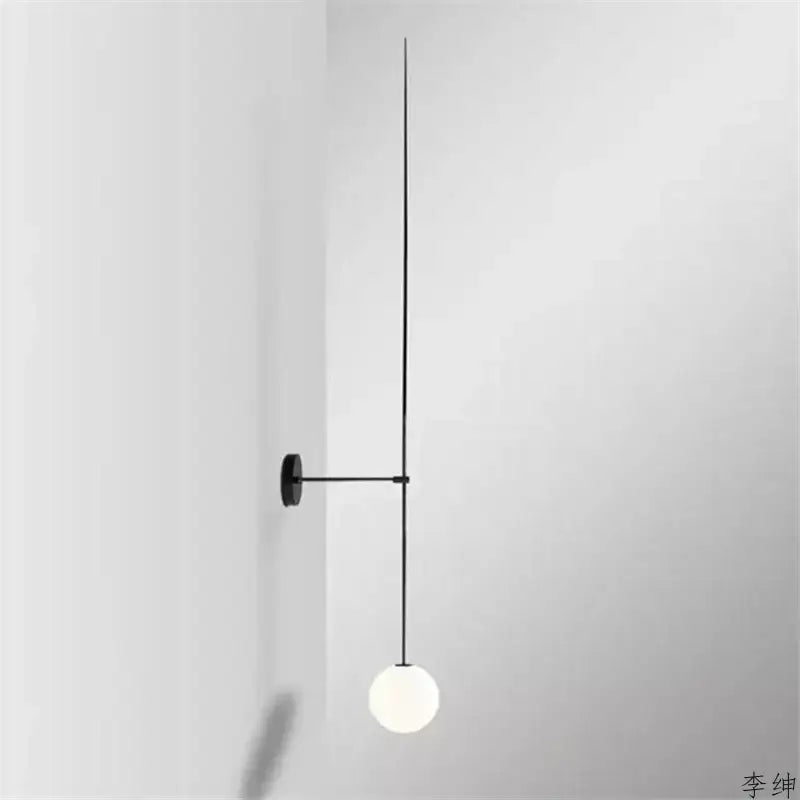Minimalist black wall light with slender rod and frosted glass ball led designed for bedroom decorbites glass ball sconce
