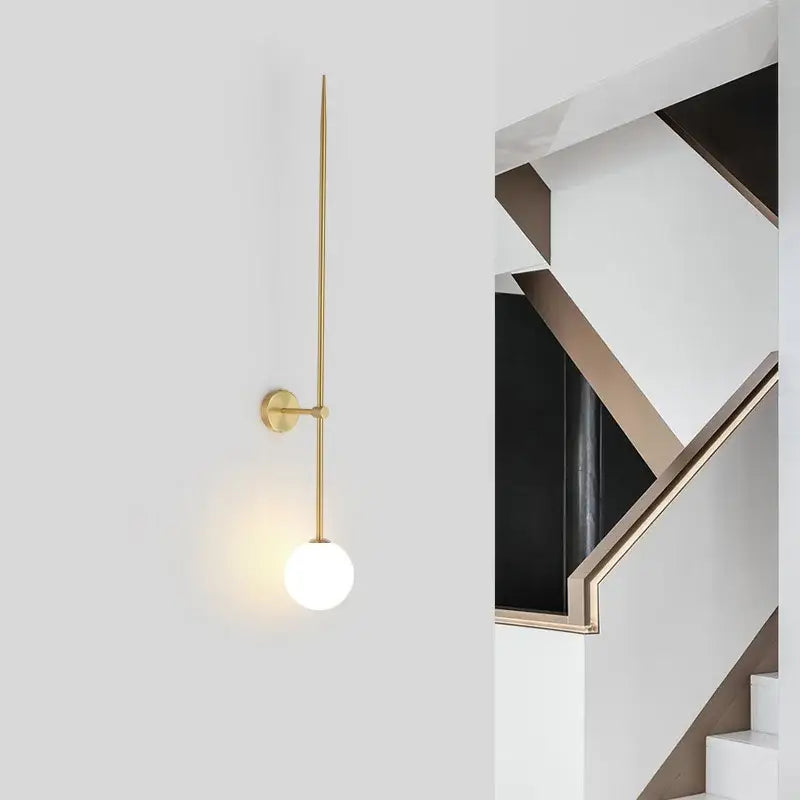 Gold-toned wall lights with slender stem and frosted glass ball led suitable for minimalist living room decorbites glass ball