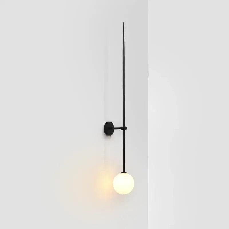 Minimalist black glass ball led wall lights feature a slender vertical rod and frosted globe for living room decorbites